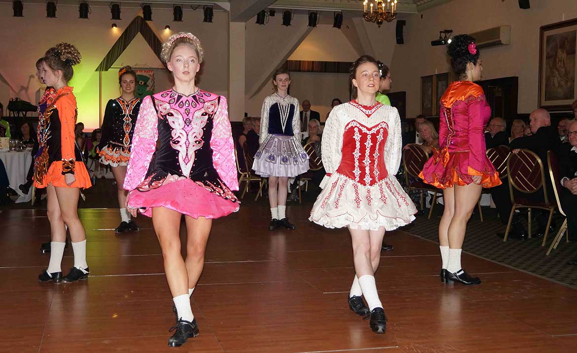 Irish society watching children dance at an event in Norwich